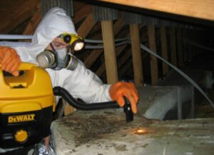 man in crawl space in biohazard suit