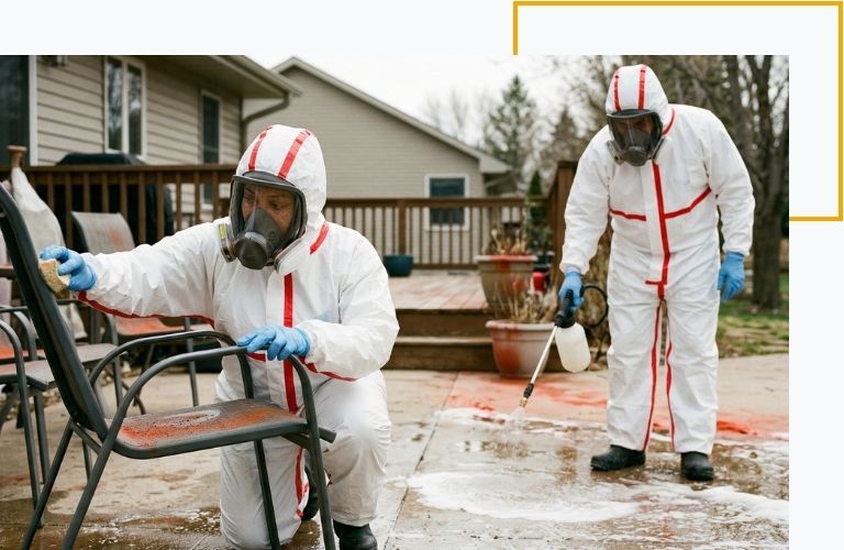 Two certified technicians utilizing biodegradable solutions to safely remove fire retardant chemicals from outdoor patio furniture.