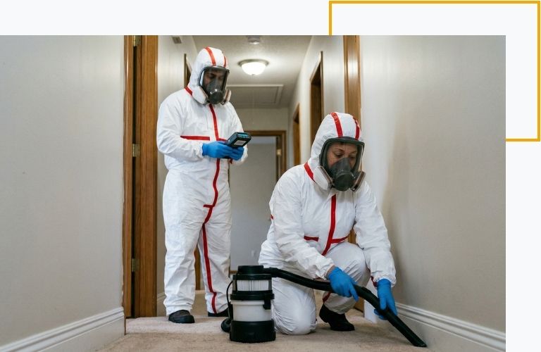 Two certified technicians utilizing HEPA filtration and air quality monitors to safely decontaminate a hallway exposed to tear gas.