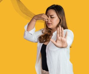 woman smelling a bad smell